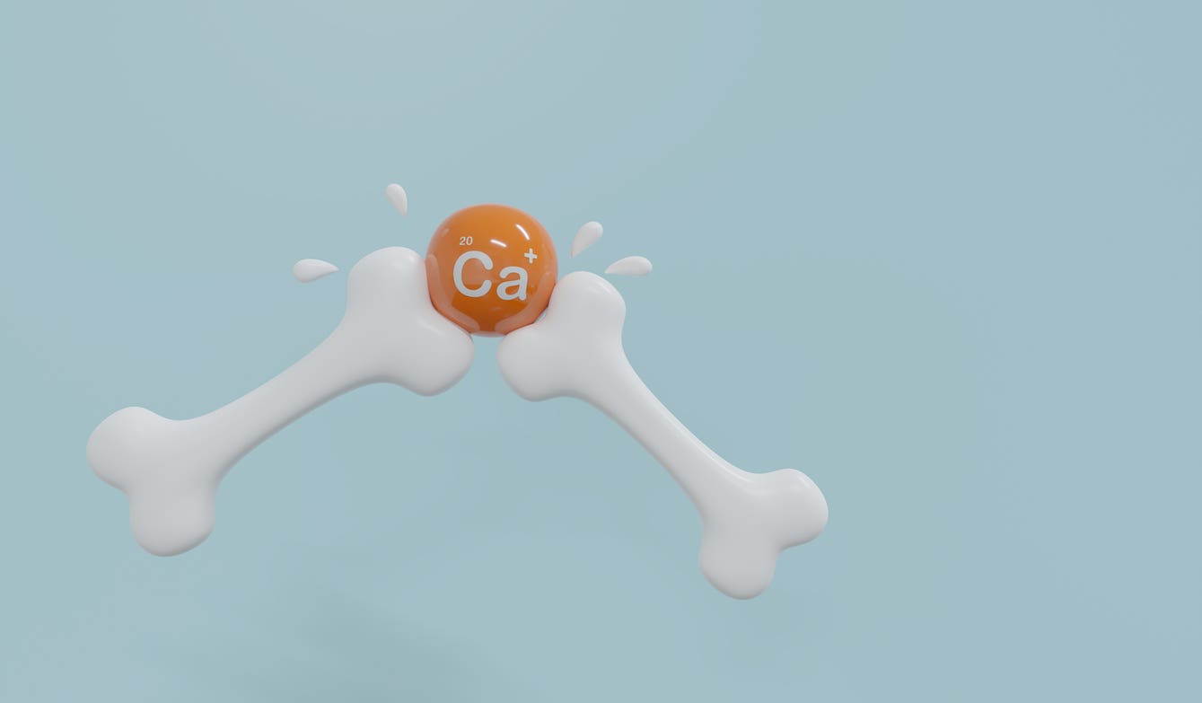 calcium-bone-image a computer-rendered image showing two plastic-looking bones intersecting at an orange ball, which has the periodic symbol for Calcium on it