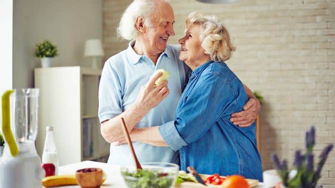 dementia-and-food An elderly couple hug each other in the kitchen
