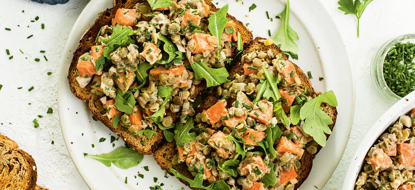 To slices of whole grain toast topped with Maple Mustard Lentils, Sweet Potatoes, and Herbs